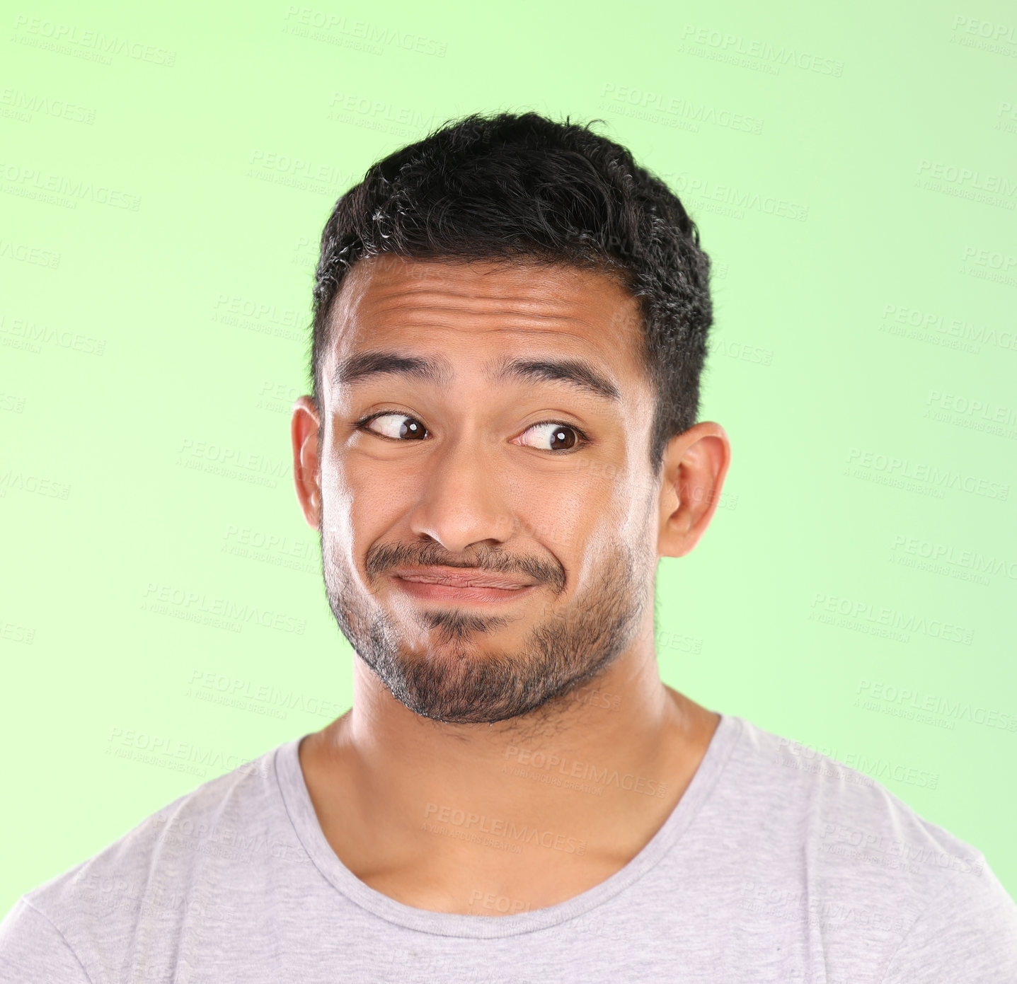 Buy stock photo Handsome man, face and awkward look with expression in disgust or dislike on a green studio background. Confused or expressive male person, unsure or puzzled emotion for mistake, unhappy or doubt