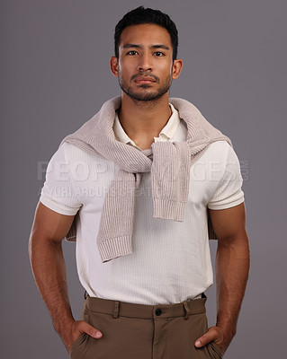 Buy stock photo Studio shot of a handsome young man posing against a grey background