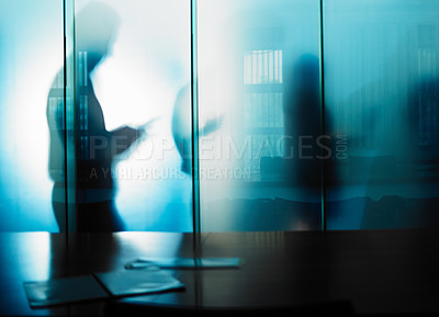 Buy stock photo Cropped shot of an unrecognizable businessman's silhouette against a glass wall in his office