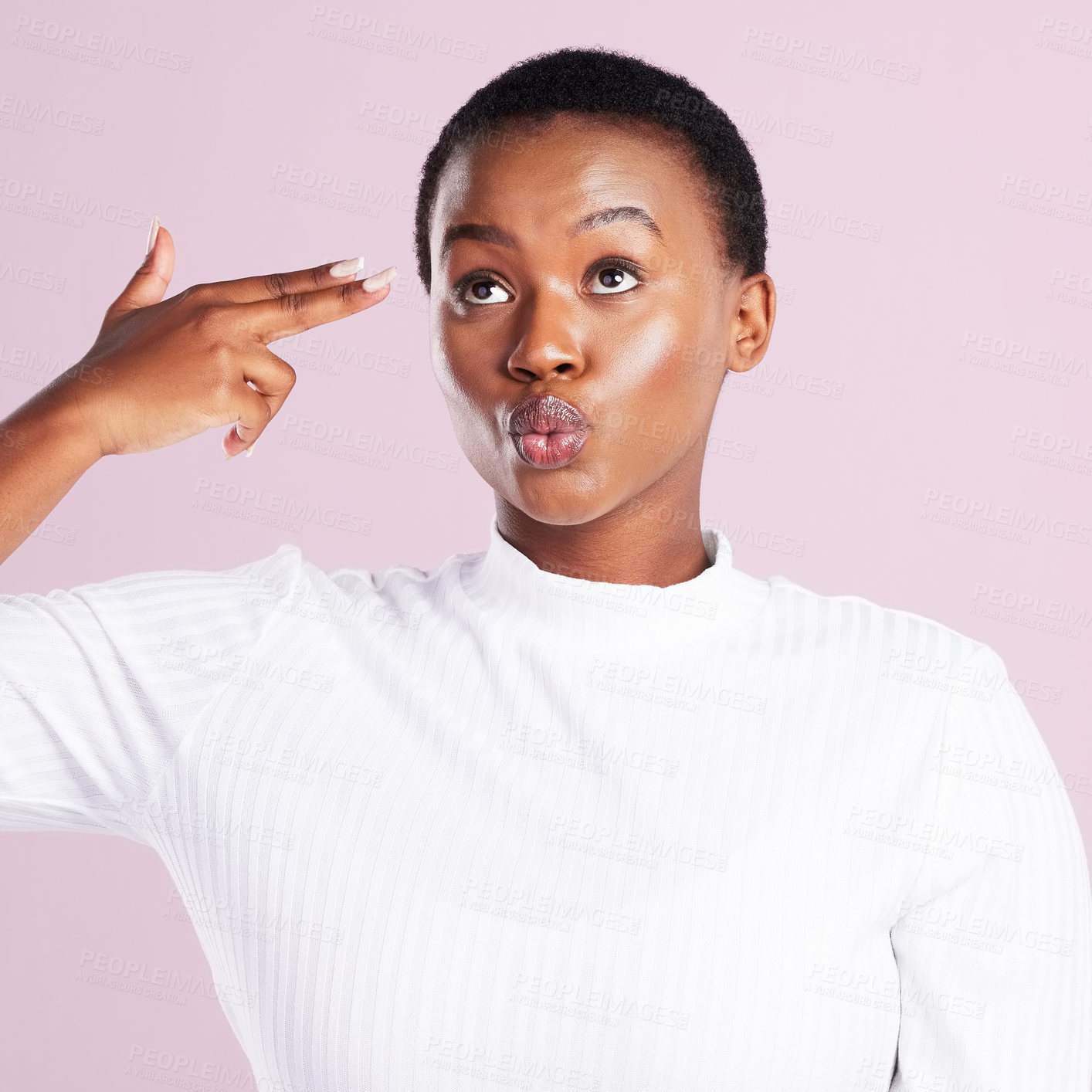 Buy stock photo Studio shot of a young woman holding up a finger gun gesture against a pink background