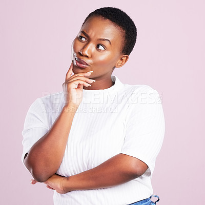 Buy stock photo Studio shot of a young woman looking thoughtful against a pink background