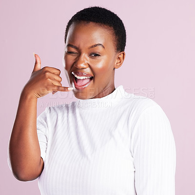 Buy stock photo Studio shot of a young woman making a shaka hand gesture against a pink background