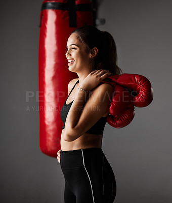 Buy stock photo Cropped shot of an attractive young female boxer training in the gym