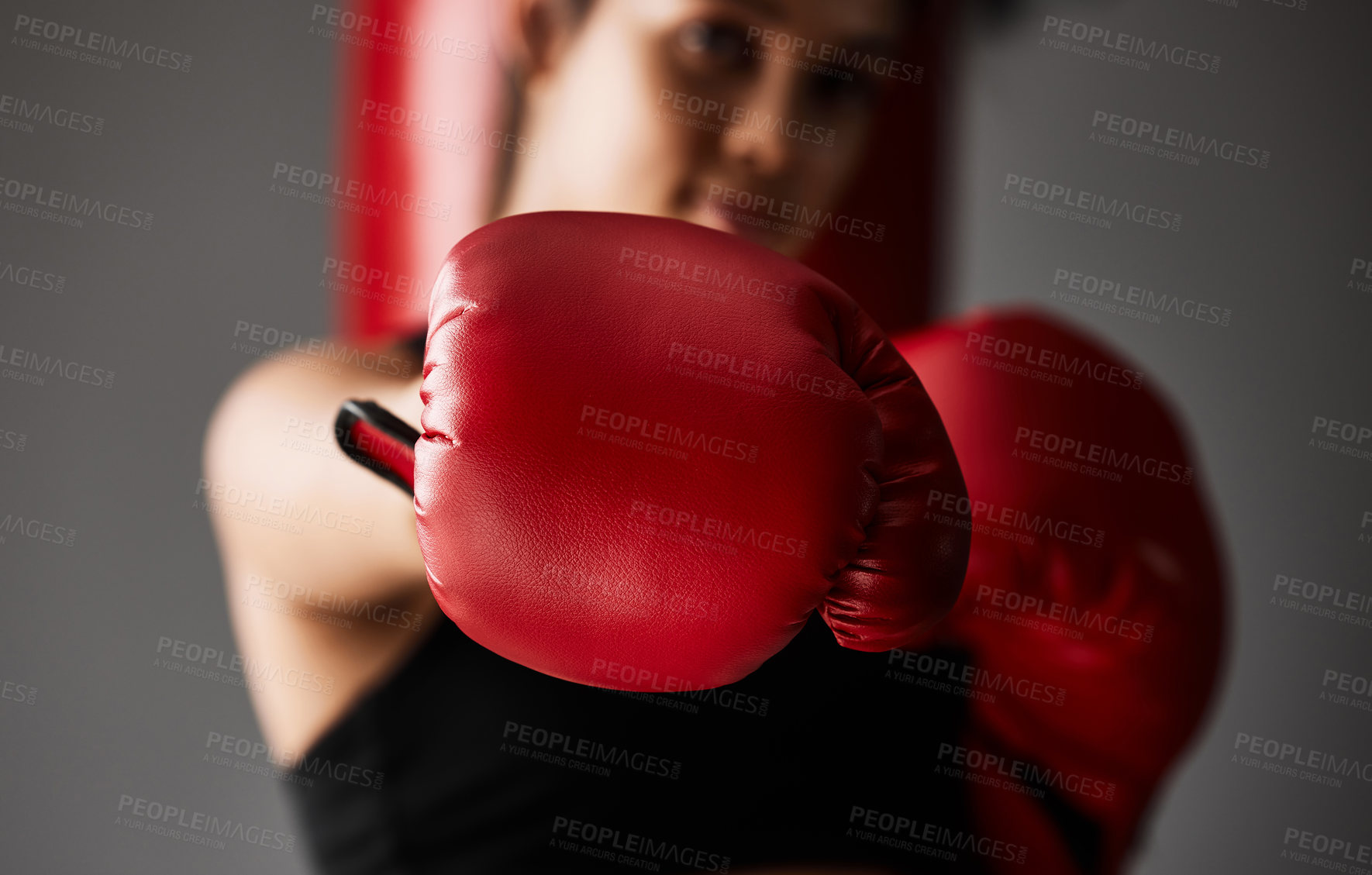 Buy stock photo Fist, boxer or woman punching in boxing training, exercise or workout in gym studio for wellness. Hand, sports athlete or strong girl fighting with red gloves, fitness or power on grey background