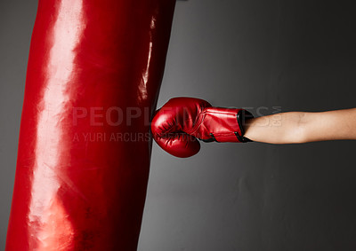 Buy stock photo Cropped shot of an unrecognizable young female boxer training in the gym