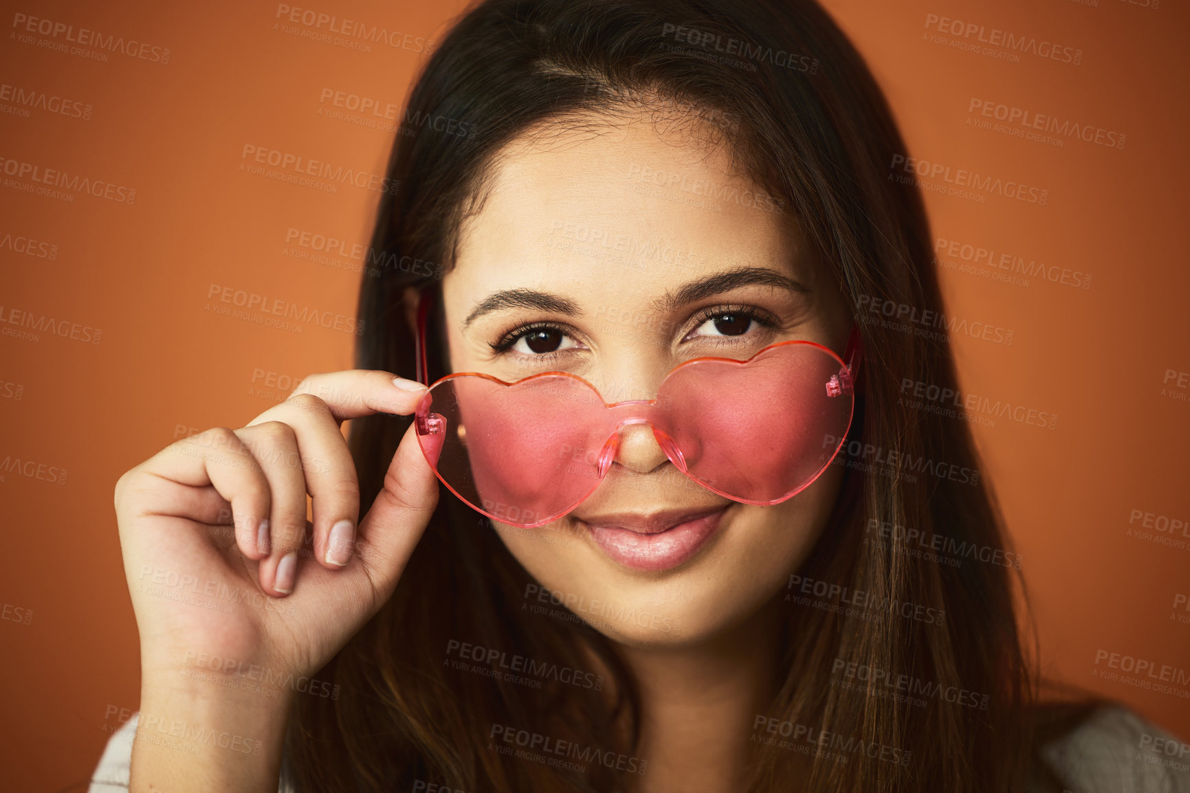 Buy stock photo Heart glasses, woman and portrait and fashion in studio with smile with hand, summer and accessory on background. Designer brand, eye care and female person with eyewear for style and happiness