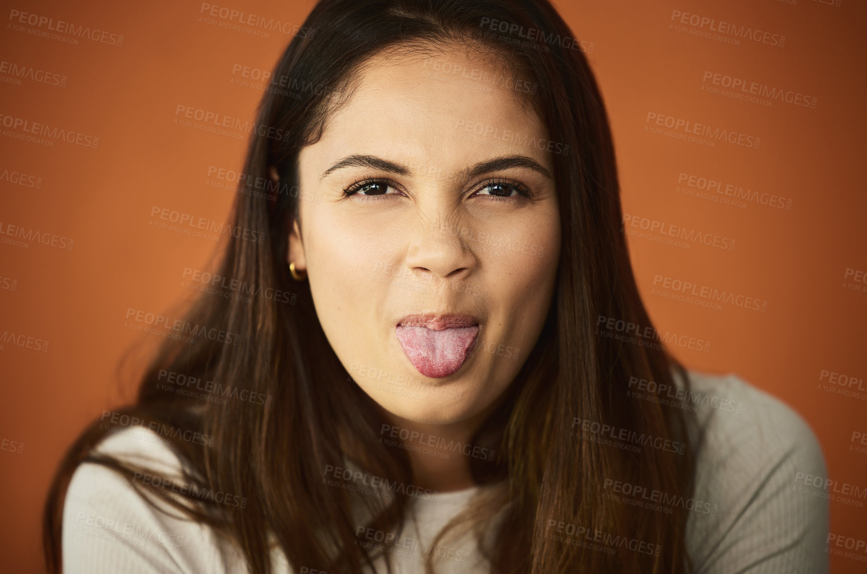 Buy stock photo Portrait, woman and tongue out in studio with emoji face for comedy, funny and happy by backdrop. Female person, crazy and goofy mood by orange background with smile for silly, meme and mouth gesture