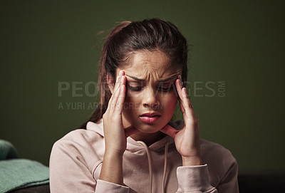 Buy stock photo Cropped shot of an attractive young woman suffering from depression against a green background