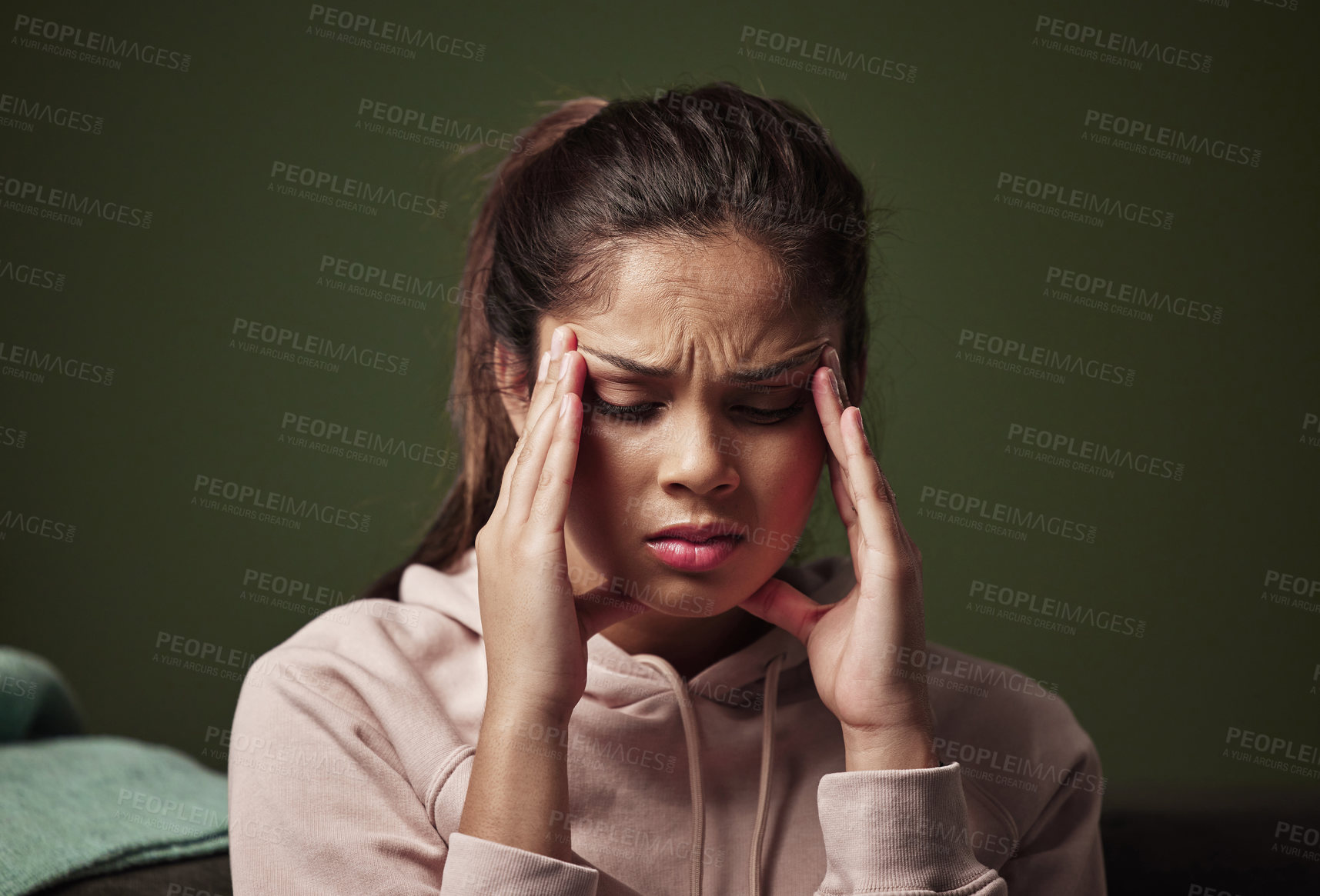 Buy stock photo Cropped shot of an attractive young woman suffering from depression against a green background