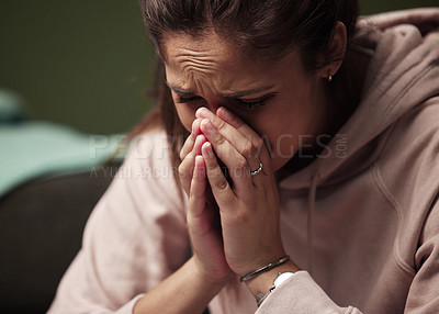 Buy stock photo Cropped shot of an attractive young woman crying against a green background