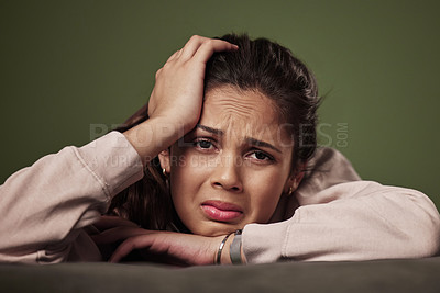 Buy stock photo Woman, stress and crying on couch for mental health with anxiety, headache and depression with unemployment crisis. Pain, frustrated and tired gen z girl in apartment for heartbreak, sad and breakup