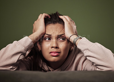 Buy stock photo Cropped shot of an attractive young woman crying against a green background