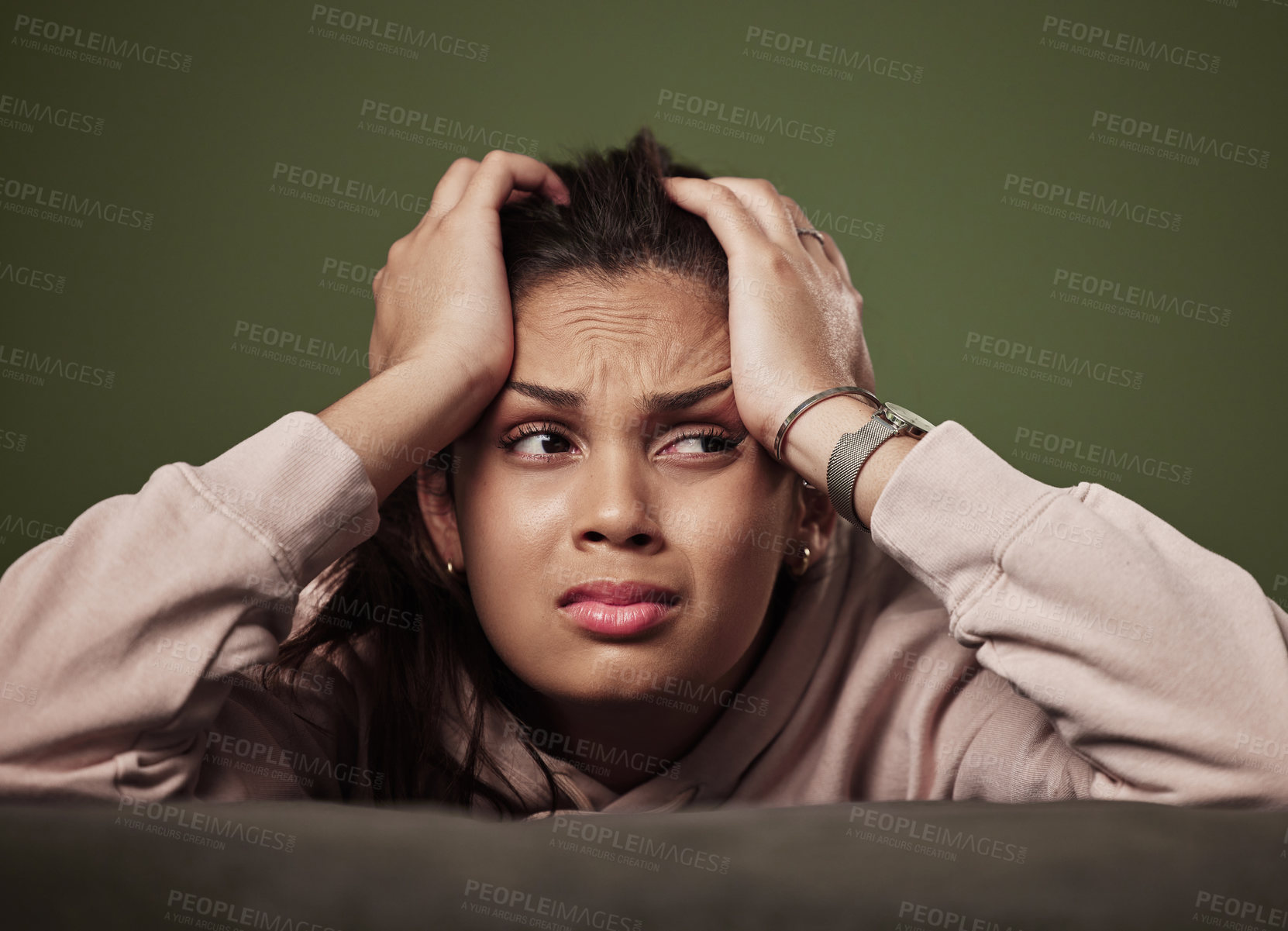 Buy stock photo Cropped shot of an attractive young woman crying against a green background