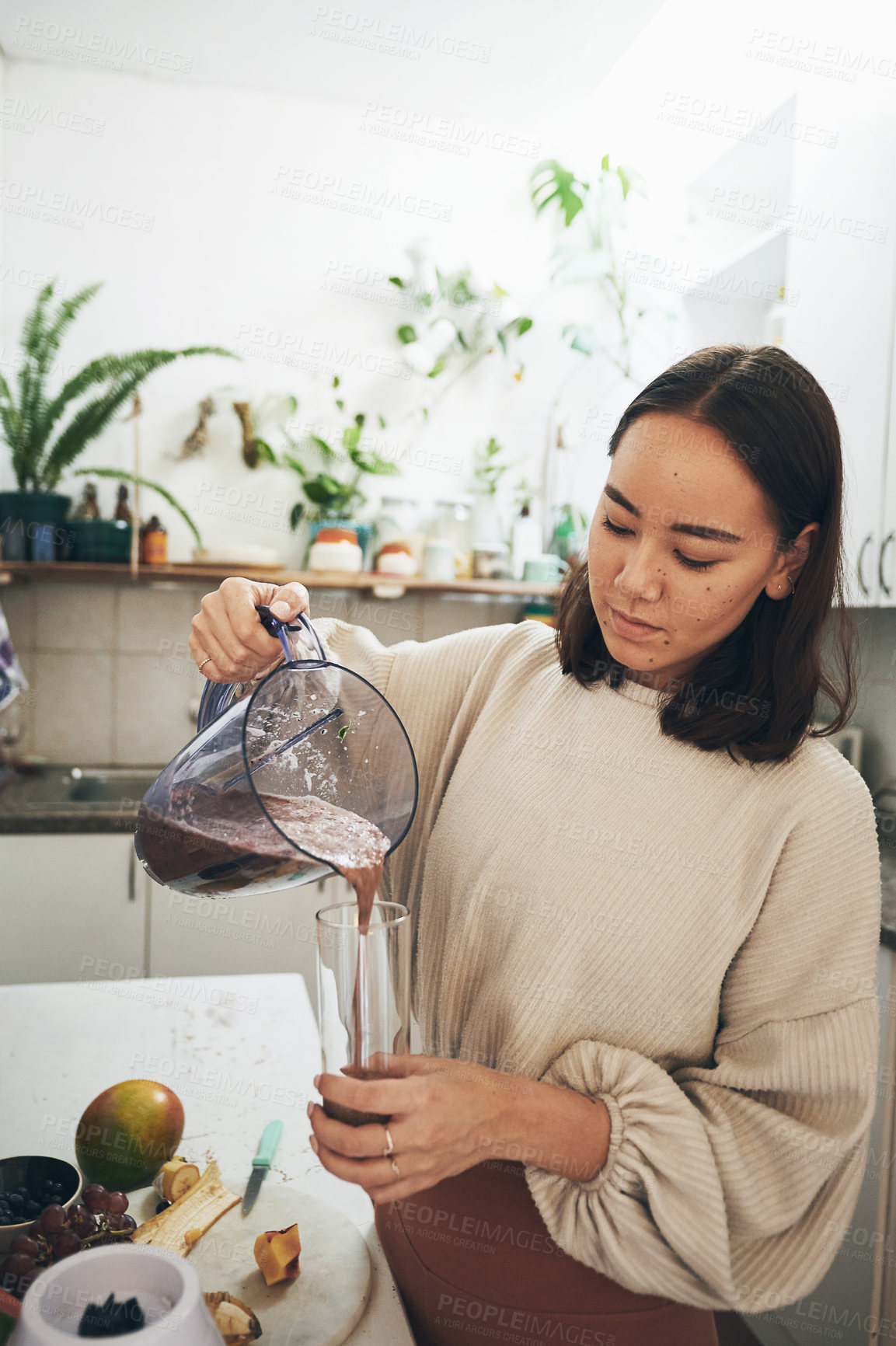 Buy stock photo Shot of a young woman using her blender to make a smoothie