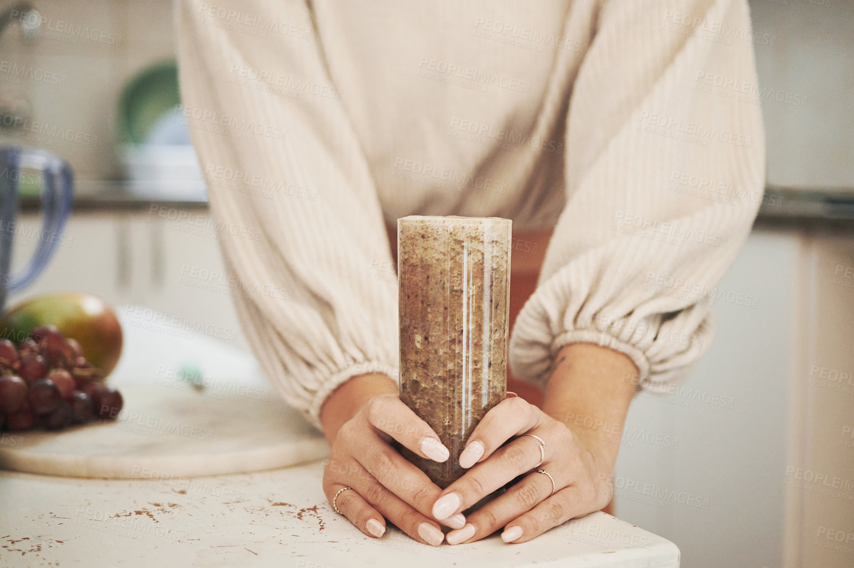 Buy stock photo Shot of an anonymous woman holding her smoothie glass