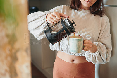 Buy stock photo Shot of a woman pouring herself a cup of coffee