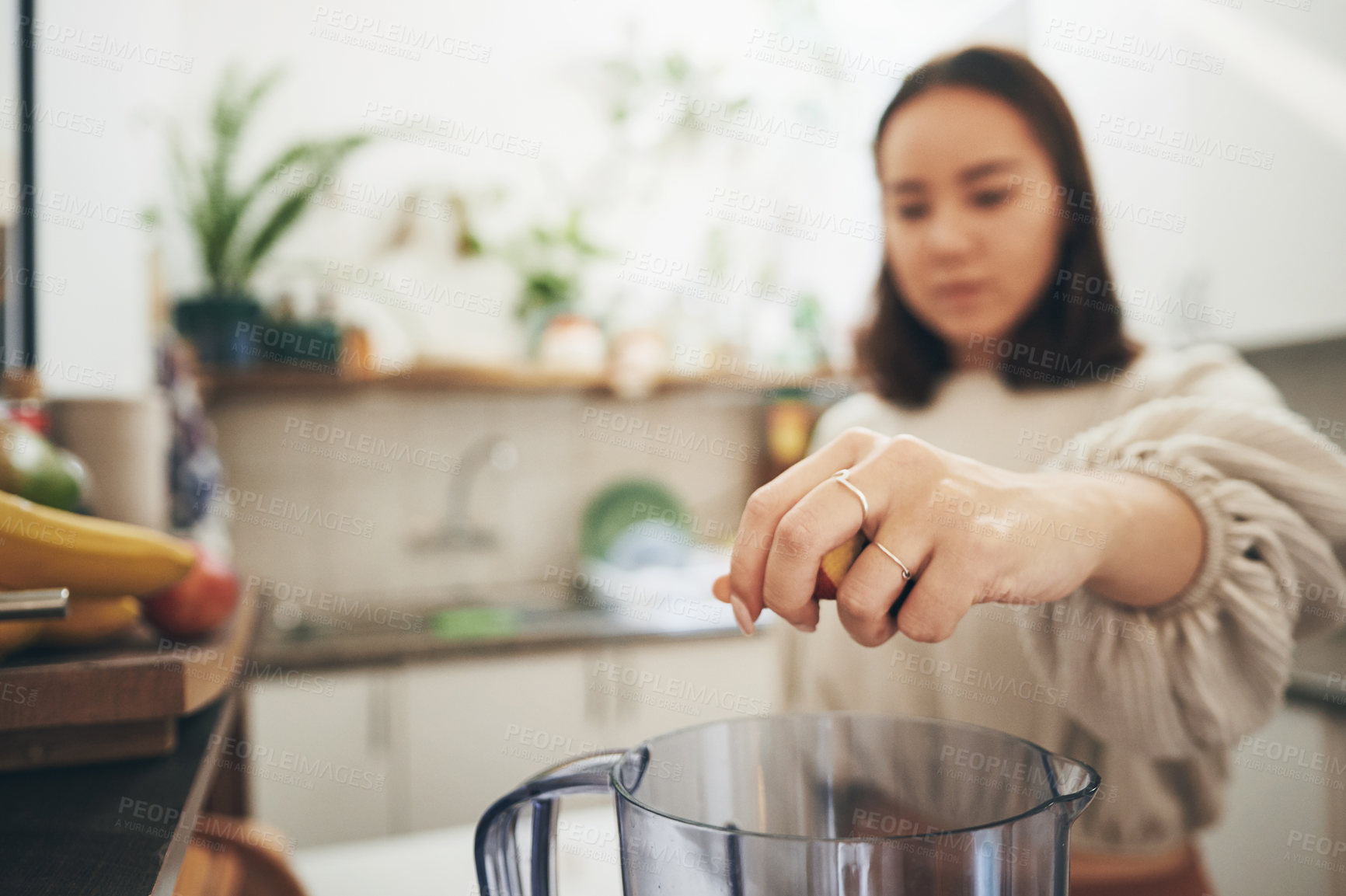 Buy stock photo Shot of a young woman using her blender to make a smoothie