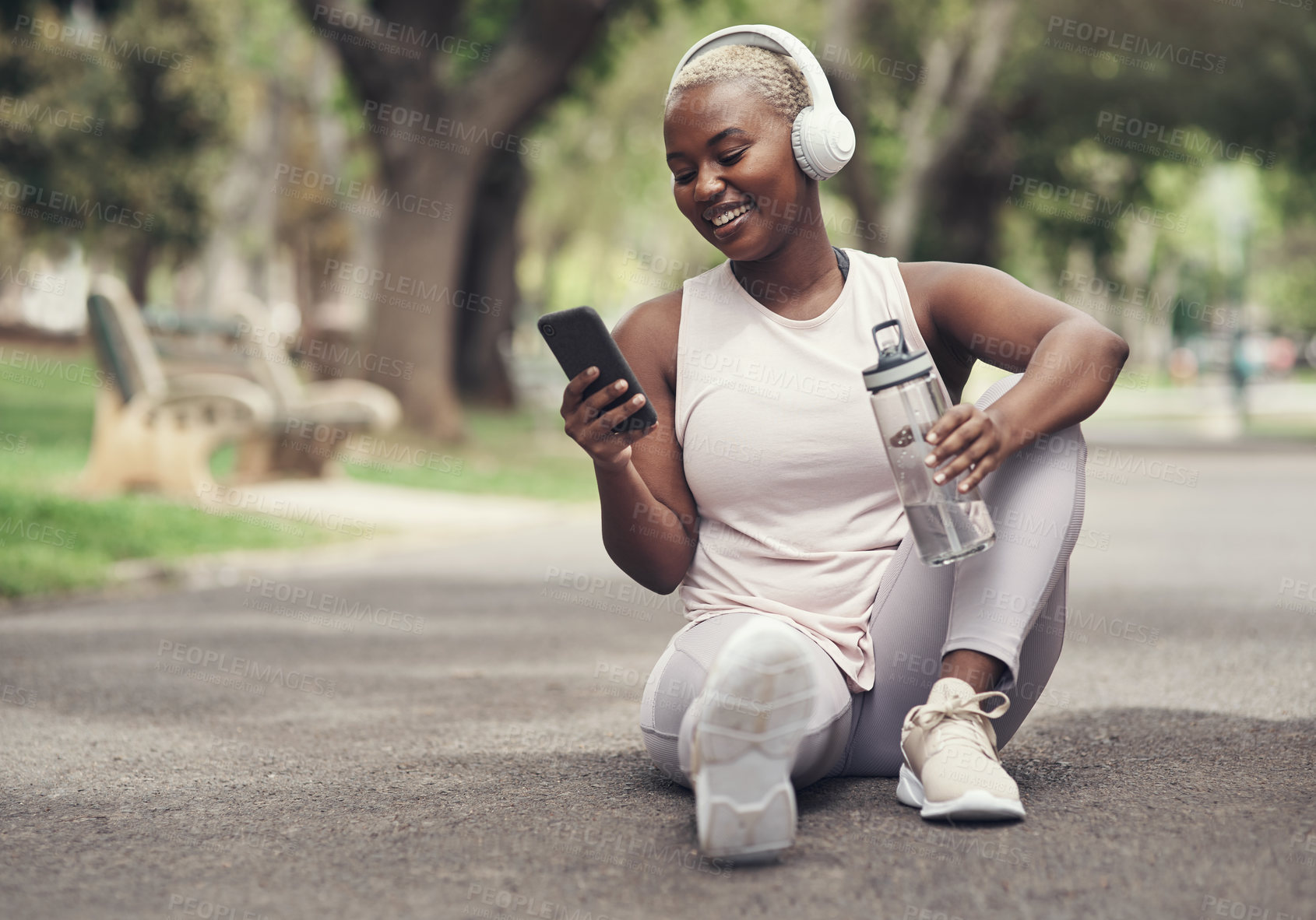 Buy stock photo Shot of a young woman taking a break during a workout