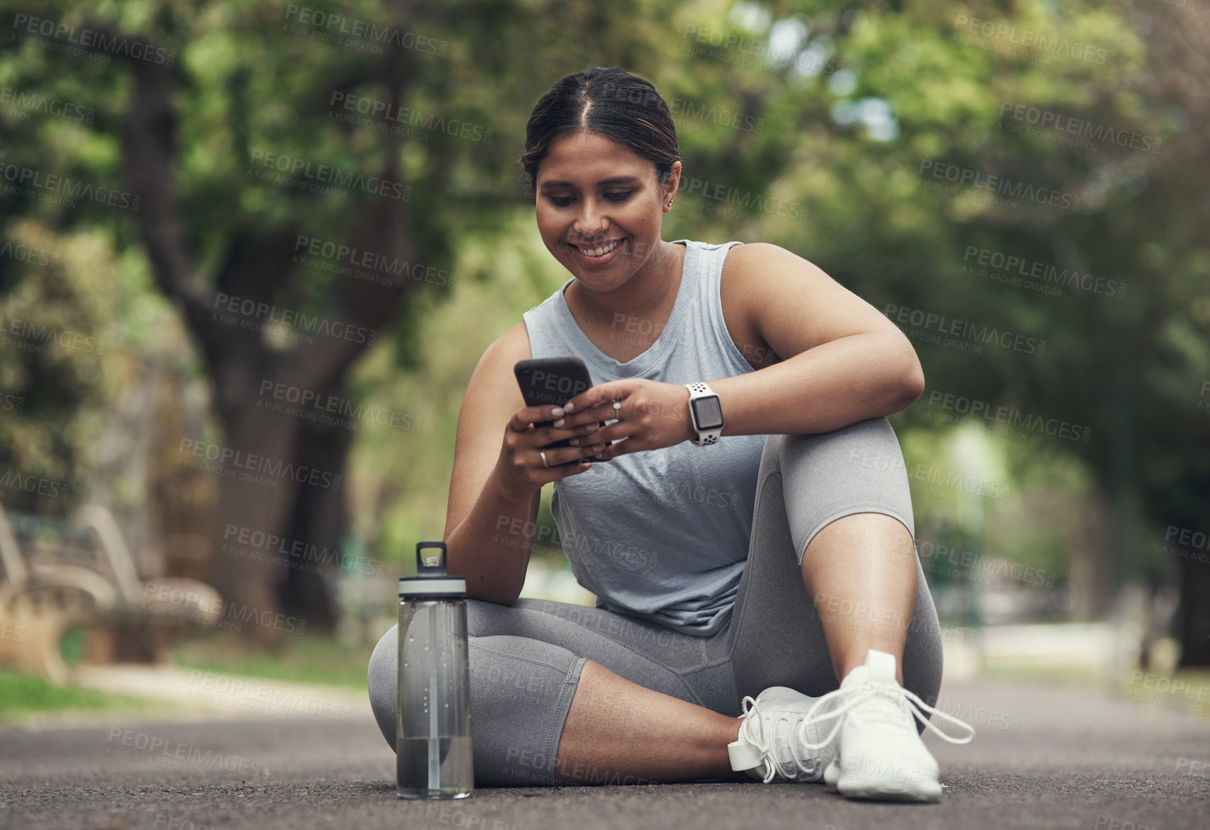 Buy stock photo Shot of a young woman taking a break during a workout