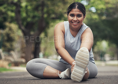 Buy stock photo Shot of a young woman stretching before working out