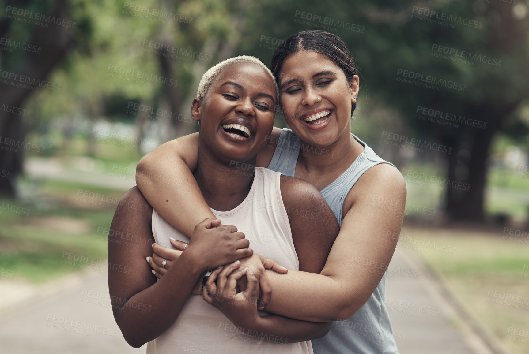 Buy stock photo Shot of two female friends taking a break during their workout