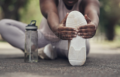 Buy stock photo Shot of a woman stretching before a workout