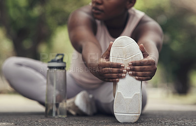 Buy stock photo Shot of a woman stretching before a workout