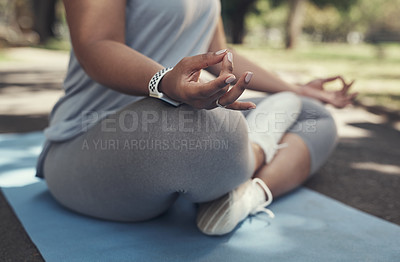 Buy stock photo Shot of a woman sitting on a yoga mat outside