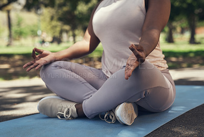 Buy stock photo Shot of a woman sitting on a yoga mat outside