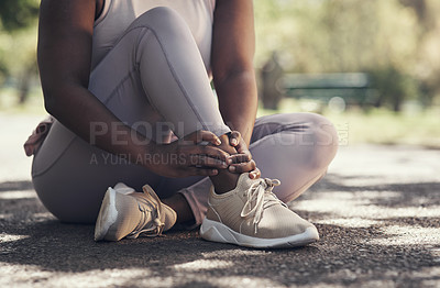Buy stock photo Shot of a woman sitting down and resting during a workout