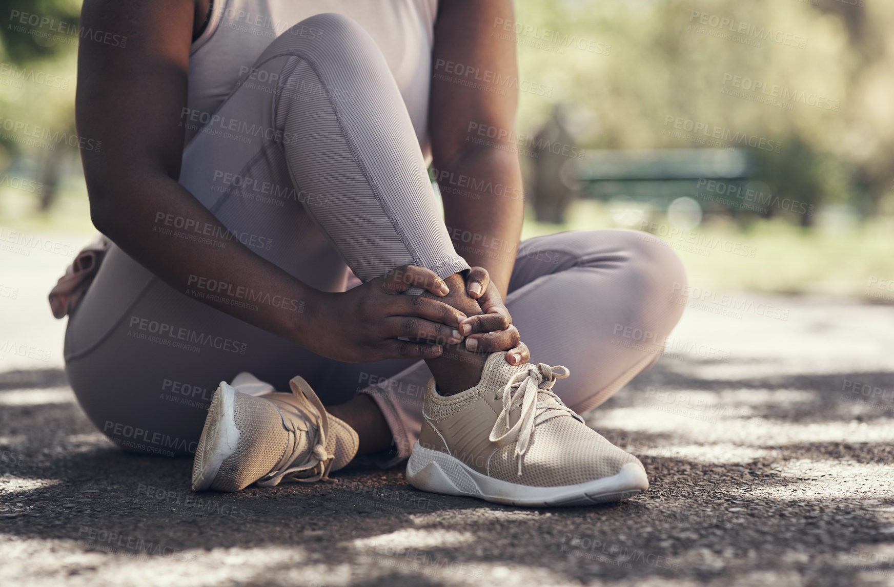 Buy stock photo Shot of a woman sitting down and resting during a workout