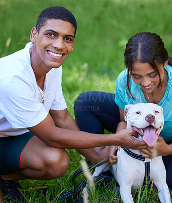 Buy stock photo Shot of a young couple with their dog enjoying a day in nature