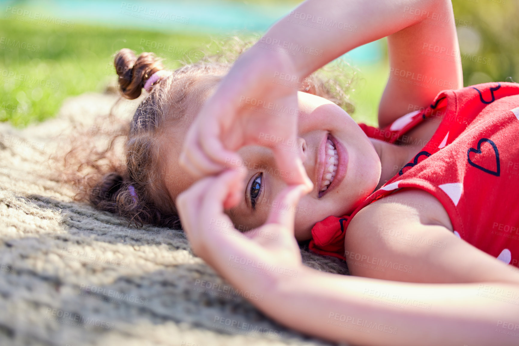Buy stock photo Portrait, smile and girl with a heart shape, outdoor and sunshine with happiness, carefree and relax. Face, female child and kid with symbol for love, freedom and cheerful with a young person and joy