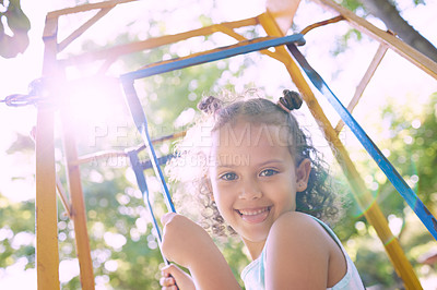 Buy stock photo Girl, smile and portrait by monkey bars, playful and excited for games, vacation and sunshine at park. Child, happy and outdoor by jungle gym in nature, summer and below with laughing at playground