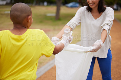 Buy stock photo Recycle, sustainability and cleaning trash at a park outdoors by a young volunteer or kid with plastic bottle. Environment, earth day and charity activists to pickup pollution for climate change