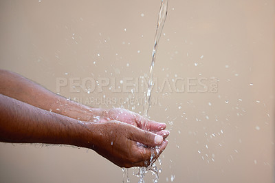 Buy stock photo Cropped shot of an unrecognizable male washing his hands under a stream of water outside