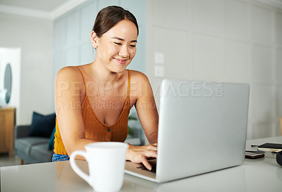 Buy stock photo Laptop, smile and woman with coffee in kitchen working on creative freelancer project at home. Technology, typing and Asian female writer reading online email with computer by counter in apartment.