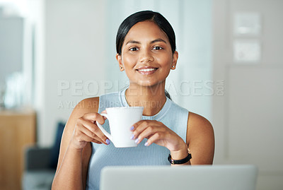 Buy stock photo Shot of an attractive young woman sitting alone at her kitchen counter and drinking coffee
