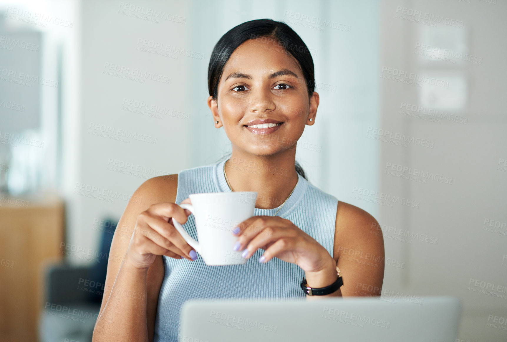 Buy stock photo Shot of an attractive young woman sitting alone at her kitchen counter and drinking coffee