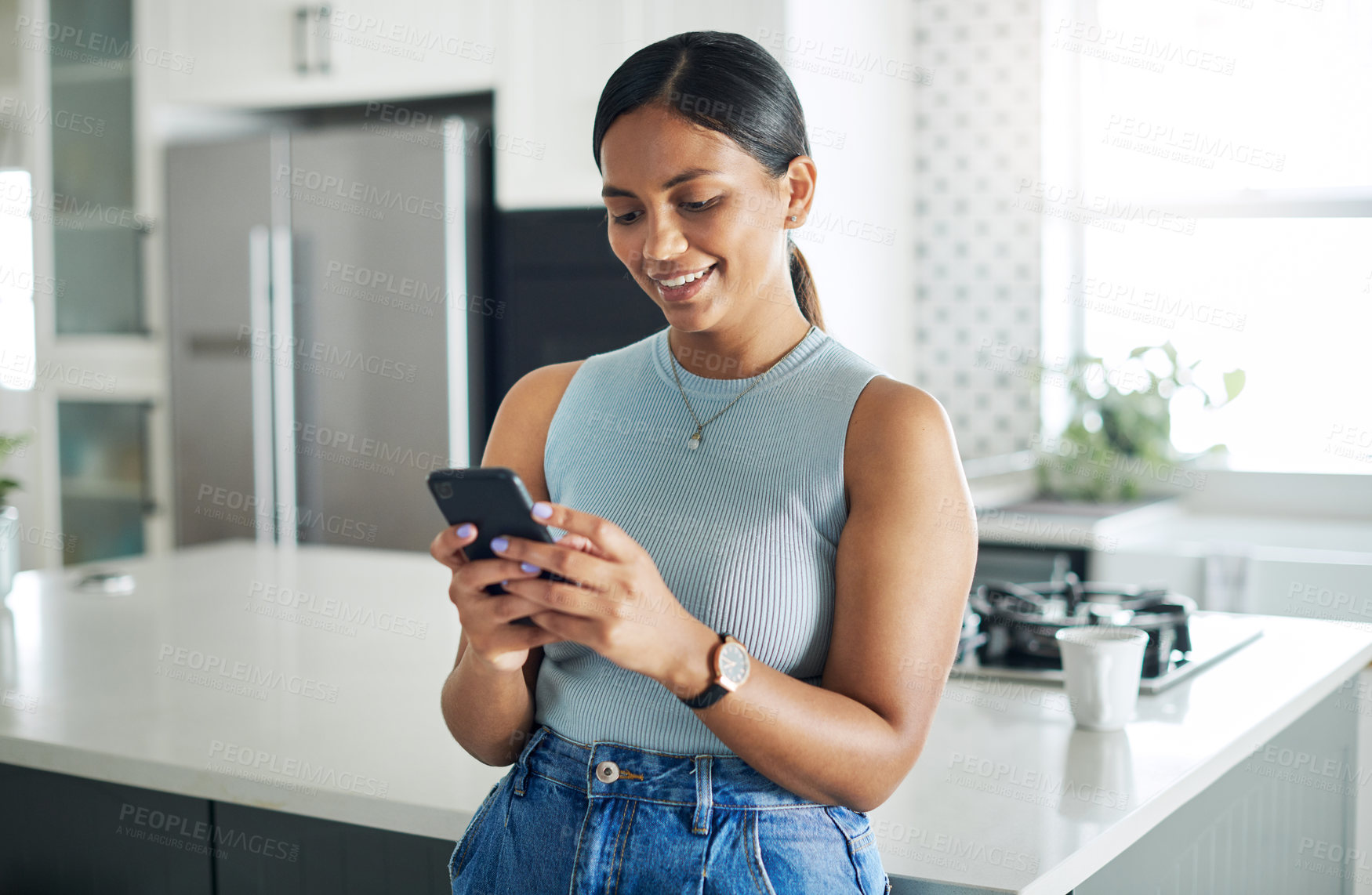 Buy stock photo Smile, phone and woman in kitchen networking on website, internet or mobile app at home. Technology, happy and young female person typing online email on cellphone by counter in modern apartment.