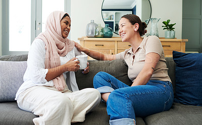 Buy stock photo Drinking coffee, smile and friends in home for talking, support or girls relax on sofa. Tea, happy women and conversation in living room, laugh or communication of interracial people bonding together