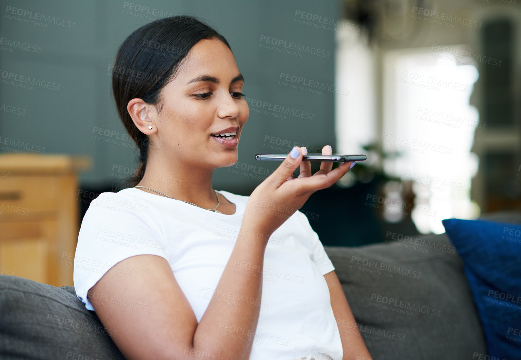 Buy stock photo Happy woman, speech and recording voice with phone for communication, audio message or note on sofa at home. Female person talking on speaker with mobile smartphone for conversation or discussion