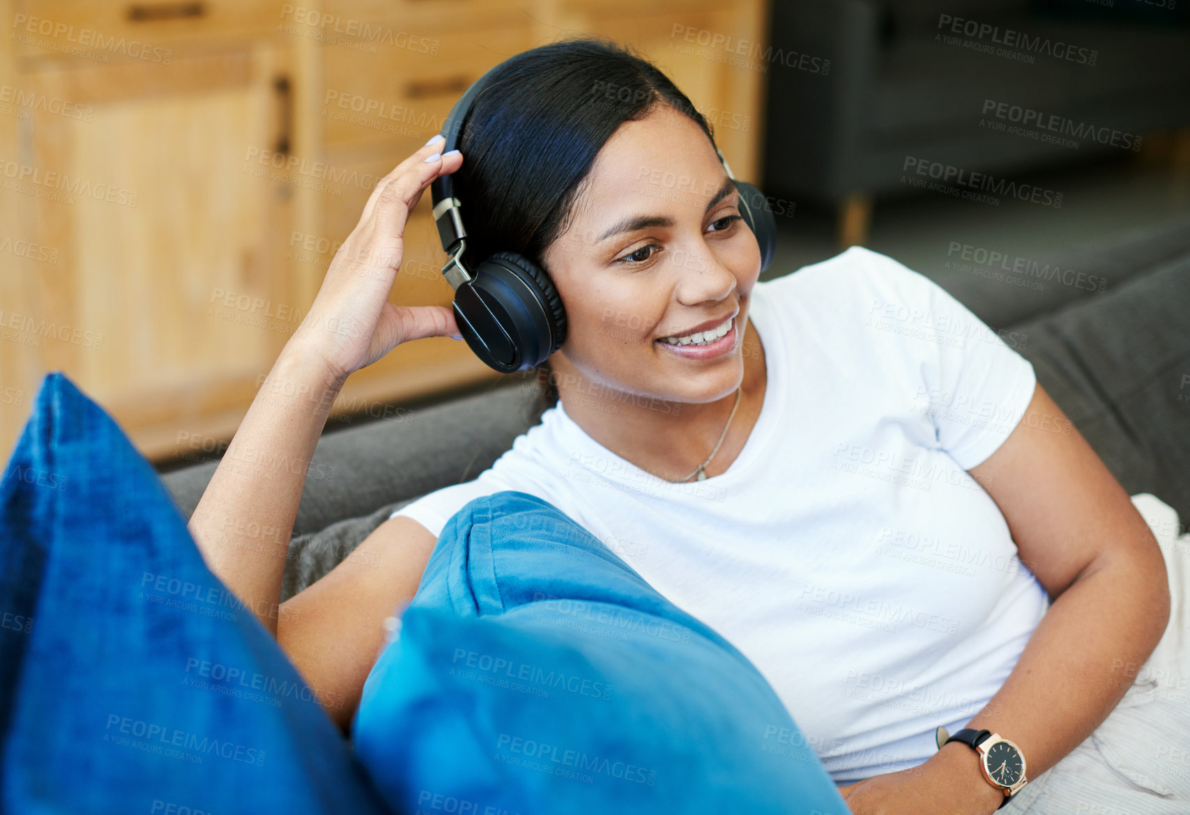 Buy stock photo Woman, headphones and smile on sofa for relax with listening to music in house with happiness. Female person, podcast and audio for streaming with calm, radio and song with weekend off at home