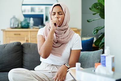 Buy stock photo Muslim, woman and sick or cough on sofa in living room with illness, flu and tired at home. Female person, lounge and fever with medication to relax, chill and calm on couch for recovery or rest
