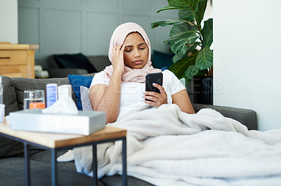 Buy stock photo Woman, muslim and phone for headache in home, cold and medicine for illness and treatment for health. Female person, hijab and migraine on couch for burnout, pills and stress for crisis or head pain