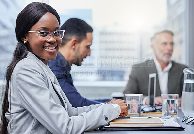 Buy stock photo Portrait of a young businesswoman having a meeting with her colleagues in a boardroom