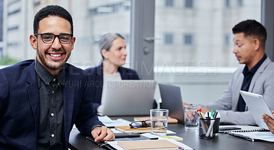 Buy stock photo Portrait of a young businessman having a meeting with his colleagues in a boardroom