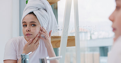 Buy stock photo Shot of a young woman cleaning her face