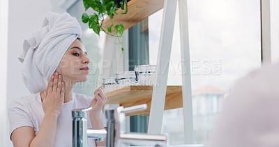 Buy stock photo Shot of a young woman cleaning her face