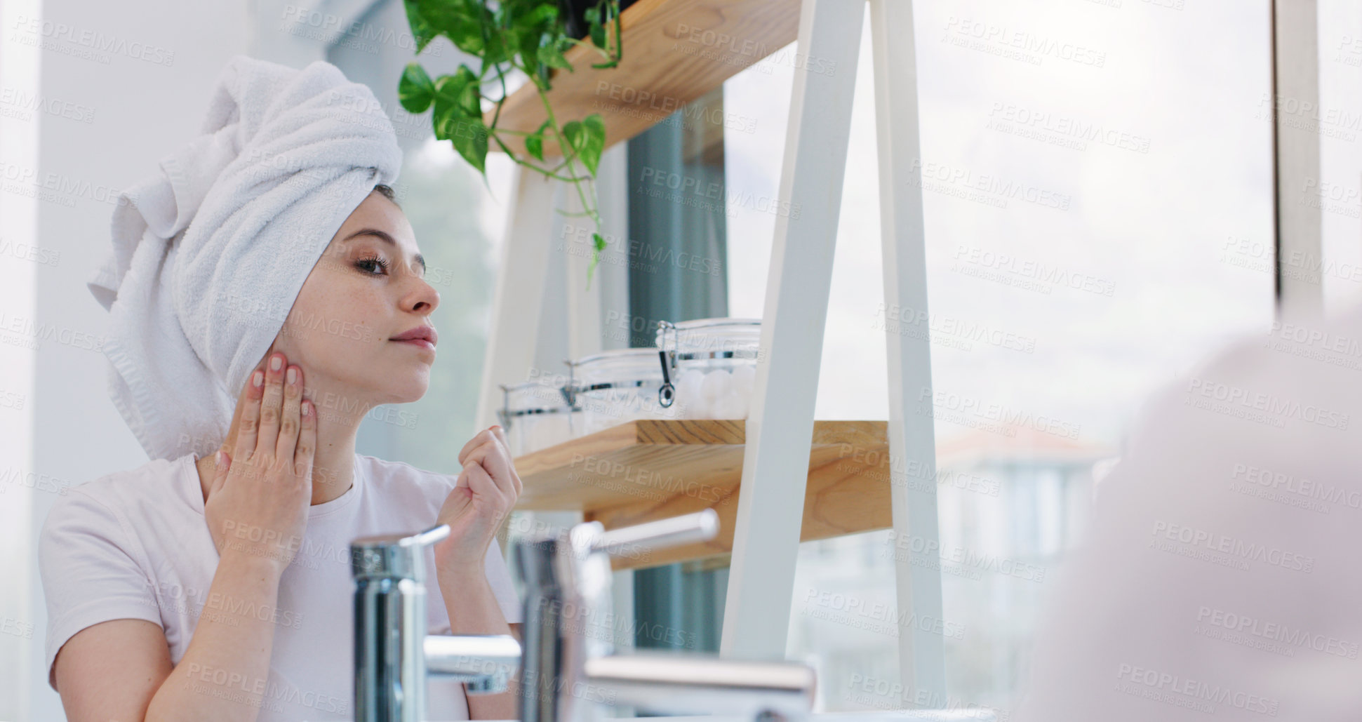 Buy stock photo Shot of a young woman cleaning her face